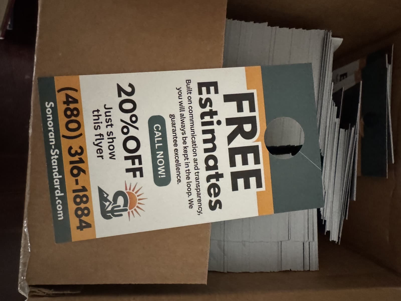 Box of Sonoran Standard door hangers, back side with the free estimate offer