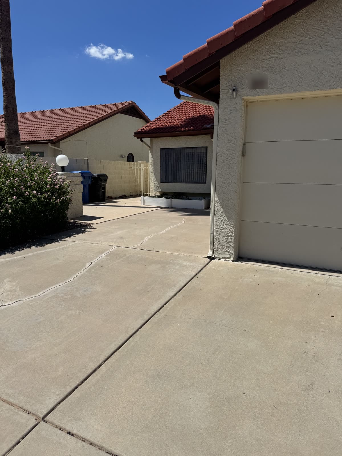 Cleared driveway and closed garage door after a junk removal pickup