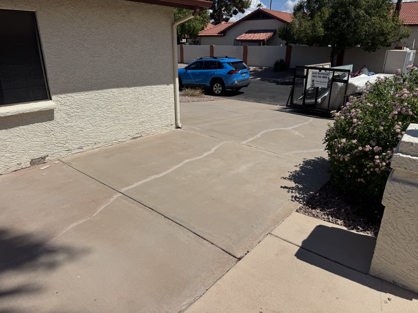 Empty swept driveway after a junk removal pickup in the East Valley